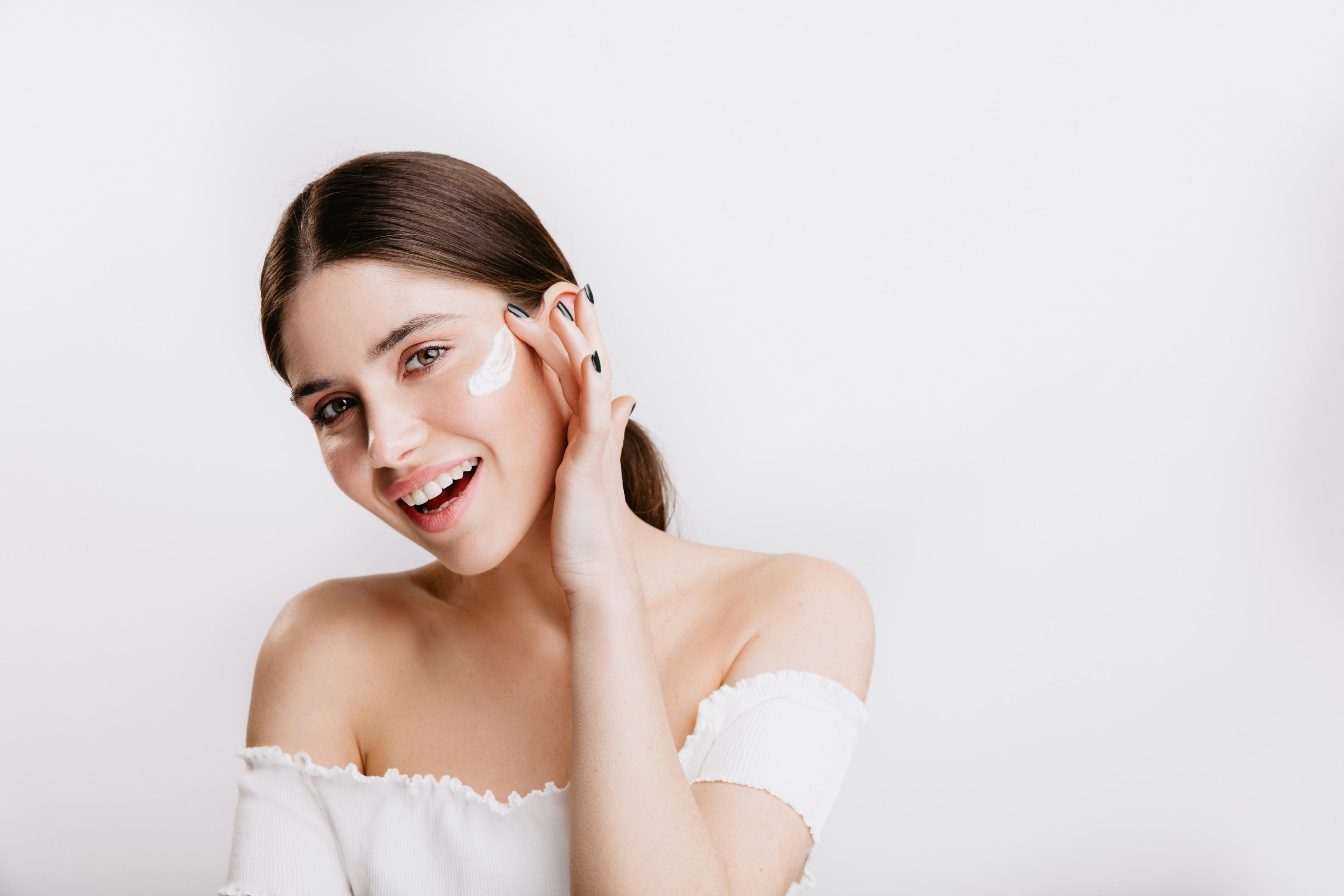Young woman applying cream