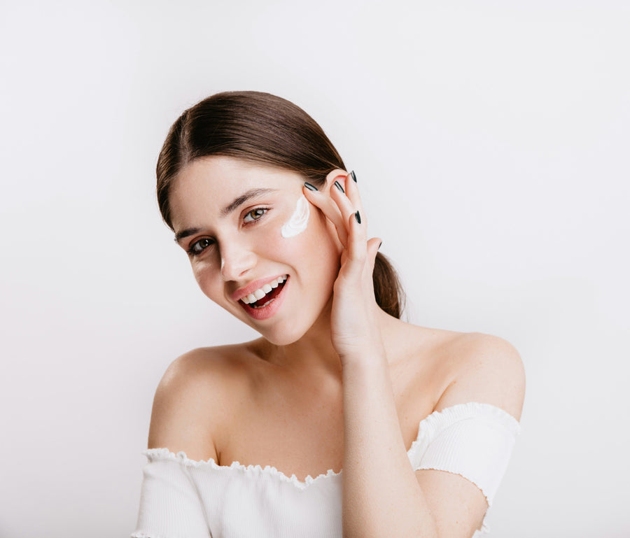 Young woman applying cream